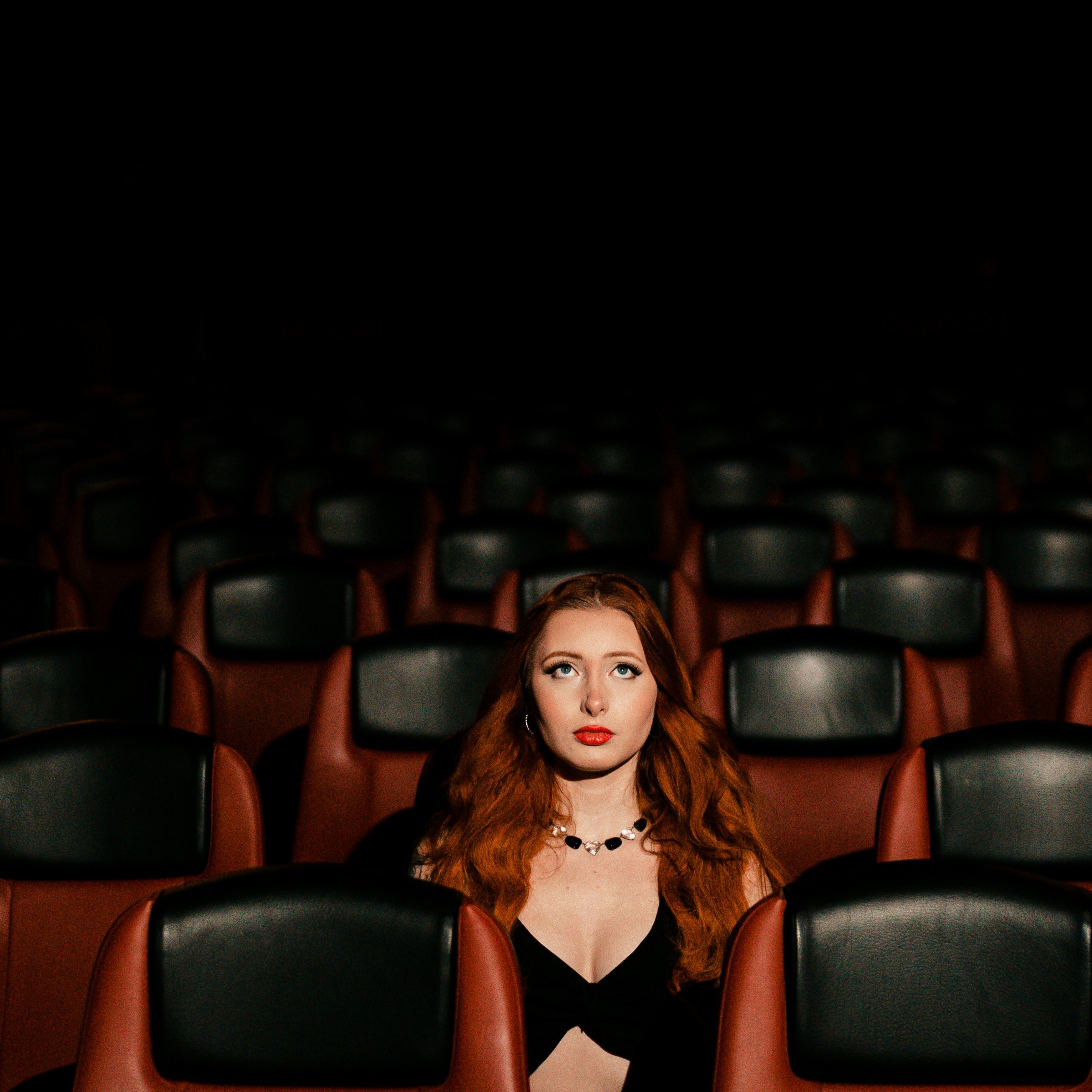 woman with red hair in movie theater